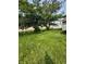 A large, grassy backyard with shade trees offers tons of space at 4908 Elmhurst Dr, Indianapolis, IN 46226