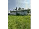 Exterior view of home with a chimney, siding, and lush green yard at 4908 Elmhurst Dr, Indianapolis, IN 46226