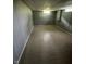 Finished basement featuring paneled walls and tiled floors with bright overhead lighting and a small window at 4908 Elmhurst Dr, Indianapolis, IN 46226