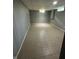 Finished basement area featuring paneled walls and tiled floors and bright overhead lighting at 4908 Elmhurst Dr, Indianapolis, IN 46226