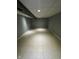 Unfurnished basement with tile floors and paneled walls with recessed lighting at 4908 Elmhurst Dr, Indianapolis, IN 46226