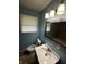 A cozy bathroom featuring a stylish sink, toilet, and tiled shower at 4908 Elmhurst Dr, Indianapolis, IN 46226