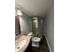 Cozy bathroom featuring a shower, toilet, and a vanity with a marbled countertop at 4908 Elmhurst Dr, Indianapolis, IN 46226