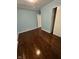 Bedroom with hardwood floors, light blue walls, and a closet featuring sliding doors at 4908 Elmhurst Dr, Indianapolis, IN 46226