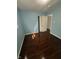 Bedroom with hardwood floors, light blue walls, and a closet featuring sliding doors at 4908 Elmhurst Dr, Indianapolis, IN 46226