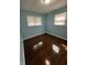 Cozy bedroom with hardwood floors, light blue walls, and two windows with blinds at 4908 Elmhurst Dr, Indianapolis, IN 46226