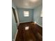 Bedroom with hardwood floors, a window with blinds, and light blue painted walls at 4908 Elmhurst Dr, Indianapolis, IN 46226