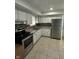 Well-equipped kitchen with stainless steel appliances, granite countertops and tiled backsplash at 4908 Elmhurst Dr, Indianapolis, IN 46226
