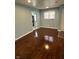 Bright living area featuring hardwood floors, neutral paint, and natural light at 4908 Elmhurst Dr, Indianapolis, IN 46226
