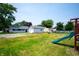 Spacious backyard featuring a playset and ample space for outdoor activities at 517 N Leland St, Fortville, IN 46040