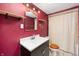 This bathroom features modern fixtures and a red accent wall at 517 N Leland St, Fortville, IN 46040