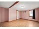 Comfortable bedroom featuring wood laminate flooring and a light fixture at 517 N Leland St, Fortville, IN 46040