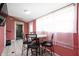 The dining area features a round table with tile flooring and bright, natural light at 517 N Leland St, Fortville, IN 46040