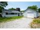 A single story house with detached garage and gravel driveway at 517 N Leland St, Fortville, IN 46040
