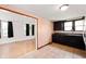 Well-lit kitchen featuring dark cabinetry, light tile floors, and an open doorway to the living room at 517 N Leland St, Fortville, IN 46040