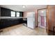 Cozy kitchen featuring black cabinets, neutral countertops, and modern stainless steel appliances at 517 N Leland St, Fortville, IN 46040