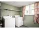 This laundry room includes a washer, dryer, and large window at 517 N Leland St, Fortville, IN 46040