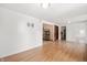 Spacious living area with wood floors that provides access to other rooms in the home at 517 N Leland St, Fortville, IN 46040