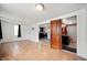 Open-concept living room with hardwood floors, connecting to the kitchen and bathroom at 517 N Leland St, Fortville, IN 46040