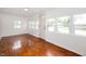 Inviting living room with beautiful hardwood floors and an abundance of natural light at 517 N Leland St, Fortville, IN 46040