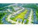 An aerial view of a housing community showcases organized street grids, manicured lawns, and a serene pond at 5199 Green Valley Ln, Noblesville, IN 46062
