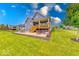 Lush backyard with patio, outdoor seating, and a covered deck, ideal for relaxation and entertaining at 5199 Green Valley Ln, Noblesville, IN 46062