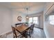 Inviting dining room with a wooden table, decorative rug, and bright natural lighting at 5199 Green Valley Ln, Noblesville, IN 46062
