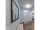 Inviting entryway featuring wood floors, a white front door, and a bench below modern wall art at 5199 Green Valley Ln, Noblesville, IN 46062