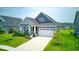 Beautifully landscaped single-Gathering home featuring an attached two-car garage and well-kept lawn at 5199 Green Valley Ln, Noblesville, IN 46062