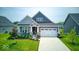 Charming single-Gathering home with a well-manicured lawn, attached garage, and inviting front porch at 5199 Green Valley Ln, Noblesville, IN 46062