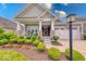 Inviting front porch with stone pillars, cozy seating, and a neatly landscaped garden at 5199 Green Valley Ln, Noblesville, IN 46062