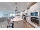 Open-concept kitchen featuring a large island, stainless steel appliances, and modern finishes at 5199 Green Valley Ln, Noblesville, IN 46062
