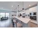 Open kitchen with a large island, white cabinets, stainless steel appliances, and pendant lighting at 5199 Green Valley Ln, Noblesville, IN 46062