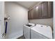The laundry room is complete with upper cabinets and newer washer and dryer at 5199 Green Valley Ln, Noblesville, IN 46062