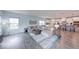 Spacious living area with modern finishes, connecting to the kitchen with a large island and bar stools at 5199 Green Valley Ln, Noblesville, IN 46062