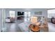 Bright living room with a large sectional sofa, modern decor, and wood flooring at 5199 Green Valley Ln, Noblesville, IN 46062