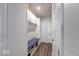 Mudroom with coat hooks, bench, storage cabinets, and wood-look flooring at 5199 Green Valley Ln, Noblesville, IN 46062