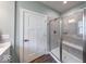 The renovated bathroom features a glass shower with gray tile and a built in bench at 5199 Green Valley Ln, Noblesville, IN 46062