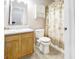 Bathroom boasts vanity, sink, mirror, toilet, shower with curtain at 5234 Melbourne Rd, Indianapolis, IN 46228