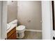 Bathroom with a toilet, sink with vanity, shower with curtain, and towel rack at 5234 Melbourne Rd, Indianapolis, IN 46228
