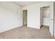 Bedroom with white walls, neutral carpet, and two open doorways at 5234 Melbourne Rd, Indianapolis, IN 46228