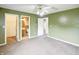 Bedroom with ceiling fan, carpet, adjacent bathroom and closet at 5234 Melbourne Rd, Indianapolis, IN 46228