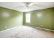Bedroom with ceiling fan, window, and green walls at 5234 Melbourne Rd, Indianapolis, IN 46228
