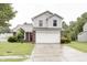 Charming two-story home with a brick and vinyl facade, a two-car garage, and a well-maintained front yard at 5234 Melbourne Rd, Indianapolis, IN 46228