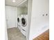 Laundry area featuring a washer and dryer, tile floor, and closet at 5234 Melbourne Rd, Indianapolis, IN 46228