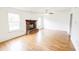 Spacious living room featuring a brick fireplace, hardwood floors, and natural light from large windows at 5234 Melbourne Rd, Indianapolis, IN 46228