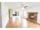 Living room showcases a brick fireplace, hardwood floors, open access to the kitchen and large windows at 5234 Melbourne Rd, Indianapolis, IN 46228