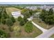 Aerial view of home with a long driveway, outbuilding, mature trees, adjacent farmland and neighborhood at 5538 N 700 W, McCordsville, IN 46055