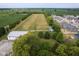 Aerial view of acreage showcasing home, garage, and open land with neighborhood nearby at 5538 N 700 W, McCordsville, IN 46055