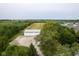 Aerial view of a large outbuilding with three garage doors, mature trees, and farmland at 5538 N 700 W, McCordsville, IN 46055